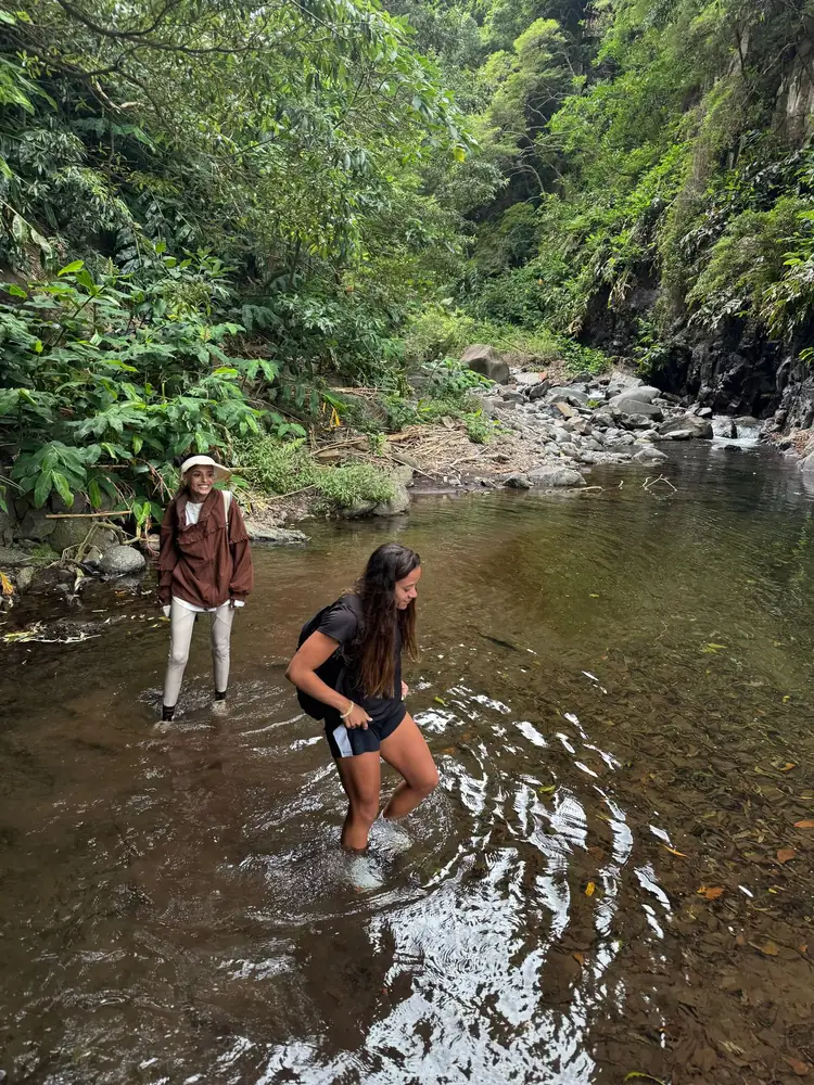 Hidden Waterfall guests crossing the stream