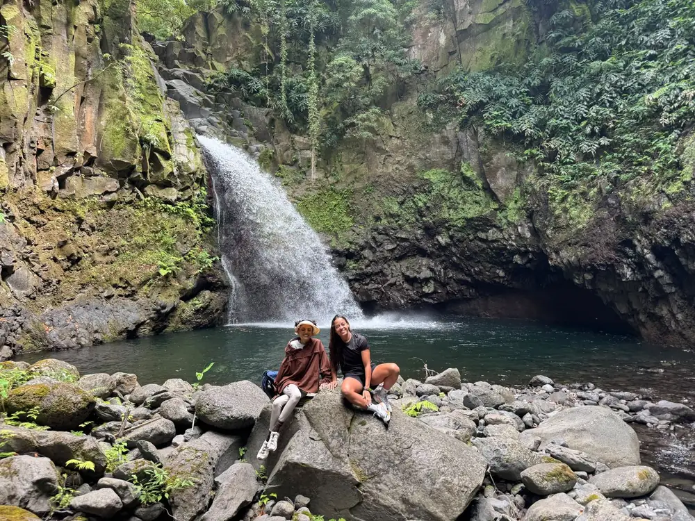 Hidden Waterfall hikers sitting by the pool
