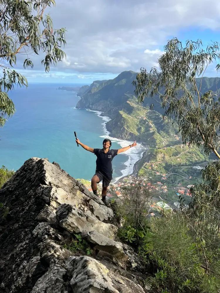 Penha D'Aguia hiker celebrating above Porto da Cruz