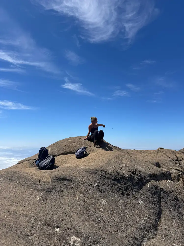Pico Grande hiker resting on rock