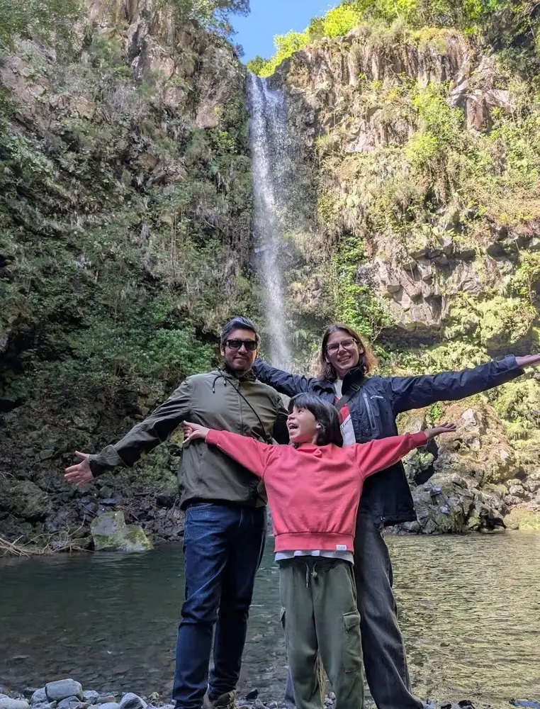 Private Island Tour guests at a tall waterfall